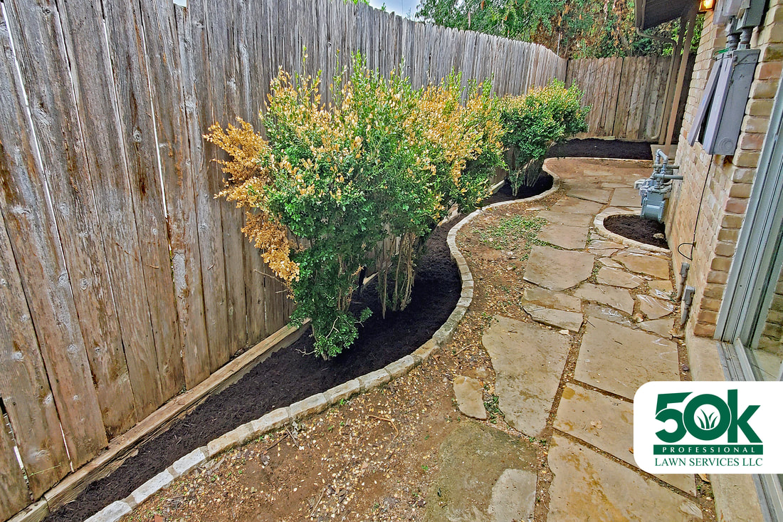Landscape perfection in South Austin with sleek brown mulch installation.